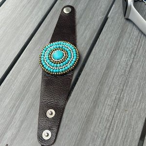 Brown leather snap bracket with blue silver and gold stones